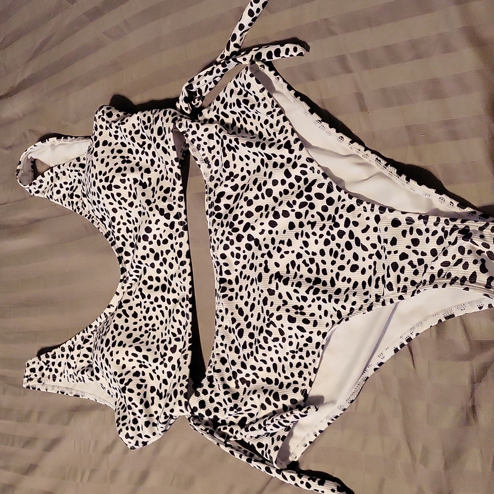 Brand new swim suit.  Looks like a 2 piece.  White with dalmation/leopard print